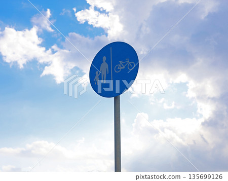 Pedestrian and Bicycle Path Sign Against Sky Pedestrian and Bicycle Path Sign Against Sky 135699126