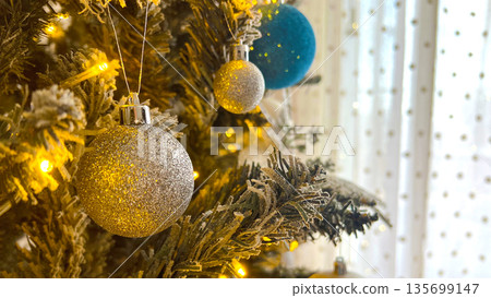Golden sparkle Christmas tree decoration close up 135699147