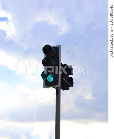 Green Traffic Signal Against Cloudy Sky 135699148