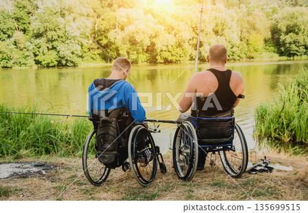 Handicapped men fishing at a lake. Wheelchair. Camping. Handicapped men fishing at a lake. Wheelchair. Camping. 135699515