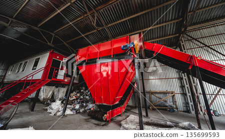 At modern recycling plant. Conveyor belt for transports garbage At modern recycling plant. Conveyor belt for transports garbage 135699593