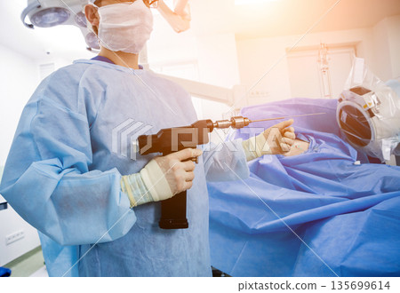 Arthroscope surgery. Orthopedic surgeons in teamwork in the operating room  135699614