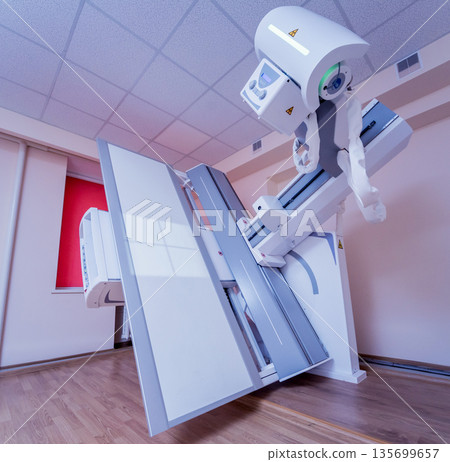 X-ray room in a hospital. Classic ceiling-mounted x-ray system. 135699657
