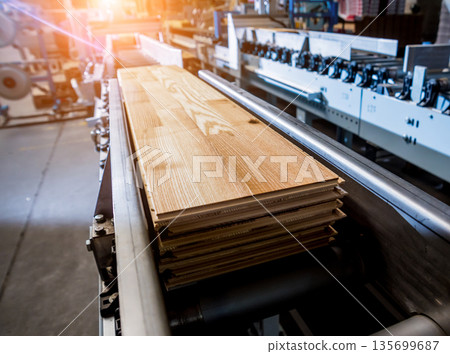Production line of the wooden floor factory. CNC automatic woodworking machine. Production line of the wooden floor factory. CNC automatic woodworking machine. 135699687