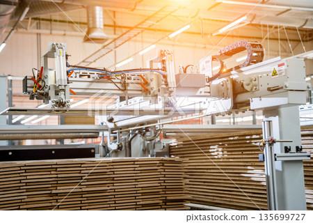 Production line of the wooden floor factory. CNC automatic woodworking machine. 135699727