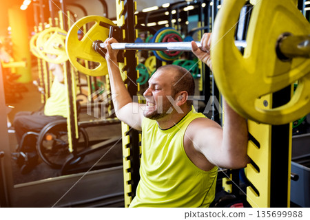 Disabled man training in the gym of rehabilitation center 135699988