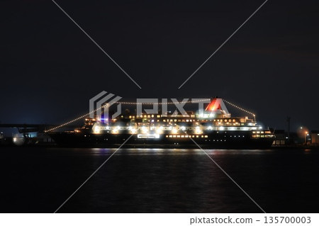 Luxury cruise ship anchored at night 135700003
