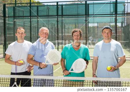 Group of men posing on padel tennis court Group of men posing on padel tennis court 135700167