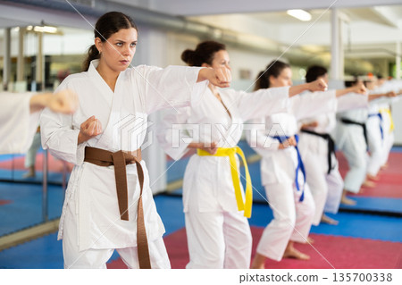 Women in a white kimono in training on a map Women in a white kimono in training on a map 135700338