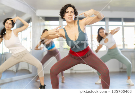 Group are practising movement in step jazz dance in fitness gym Group are practising movement in step jazz dance in fitness gym 135700403