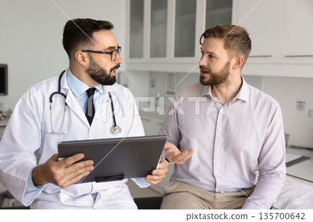 Hispanic male physician giving consultation to patient after examination Hispanic male physician giving consultation to patient after examination 135700642