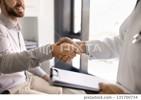 Male physician doctor and patient shaking hands Male physician doctor and patient shaking hands 135700734