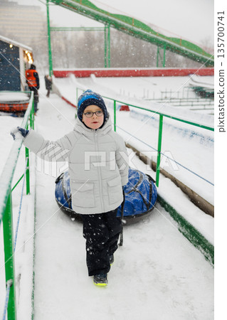 Child Enjoying Snowy Day at Outdoor Winter Park Child Enjoying Snowy Day at Outdoor Winter Park 135700741
