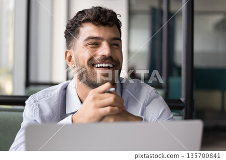 Joyful young male student enjoy work result on notebook screen Joyful young male student enjoy work result on notebook screen 135700841
