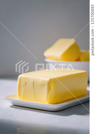 Close-up of Butter on Dish with Soft Gradient Background Lighting 135700885