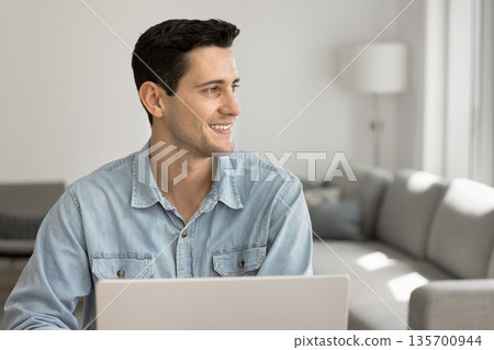 Confident young man freelancer look aside from notebook with smile 135700944
