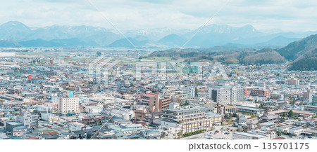 Tendo city with Sakura Cherry Blossom and snow mountain in Spring season, view from Tendo Park or Maizuru Park. Yamagata prefecture, Tohoku, Japan, 21 April 2025 135701175