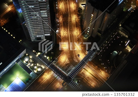 Urban intersection overlooking the city at night Urban intersection overlooking the city at night 135701332