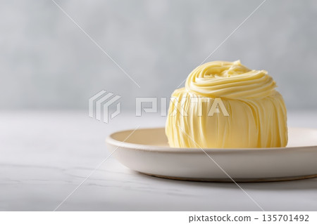 Premium Sculpted Butter on Ceramic Plate in Minimalist Food Presentation 135701492