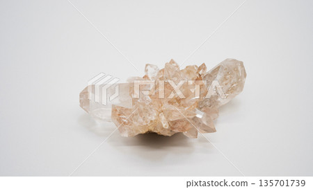 Pale pink crystal cluster on white background 135701739