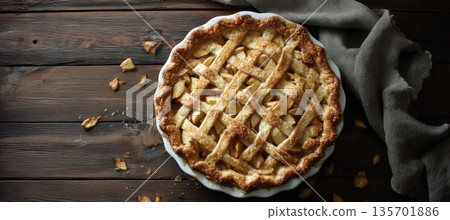 Freshly Baked Apple Pie with Lattice Crust on Rustic Wooden Table 135701886