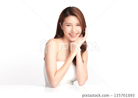 A beautiful young Asian woman with clean, fresh skin against a white background. Skincare, facial treatment, cosmetology, beauty, and spa. An elegant portrait of an Asian woman. A beautiful young Asian woman with clean, fresh skin against a white background. Skincare, facial treatment, cosmetology, beauty, and spa. An elegant portrait of an Asian woman. 135701893