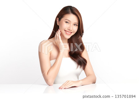 A beautiful young Asian woman with clean, fresh skin against a white background. Skincare, facial treatment, cosmetology, beauty, and spa. An elegant portrait of an Asian woman. A beautiful young Asian woman with clean, fresh skin against a white background. Skincare, facial treatment, cosmetology, beauty, and spa. An elegant portrait of an Asian woman. 135701894