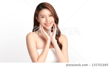 A beautiful young Asian woman with clean, fresh skin against a white background. Skincare, facial treatment, cosmetology, beauty, and spa. An elegant portrait of an Asian woman. A beautiful young Asian woman with clean, fresh skin against a white background. Skincare, facial treatment, cosmetology, beauty, and spa. An elegant portrait of an Asian woman. 135701895
