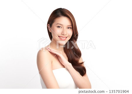 A beautiful young Asian woman with clean, fresh skin against a white background. Skincare, facial treatment, cosmetology, beauty, and spa. An elegant portrait of an Asian woman. A beautiful young Asian woman with clean, fresh skin against a white background. Skincare, facial treatment, cosmetology, beauty, and spa. An elegant portrait of an Asian woman. 135701904
