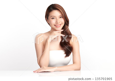A beautiful young Asian woman with clean, fresh skin against a white background. Skincare, facial treatment, cosmetology, beauty, and spa. An elegant portrait of an Asian woman. A beautiful young Asian woman with clean, fresh skin against a white background. Skincare, facial treatment, cosmetology, beauty, and spa. An elegant portrait of an Asian woman. 135701905