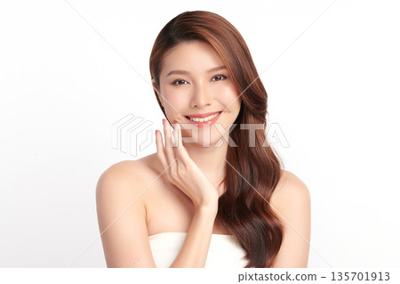 A beautiful young Asian woman with clean, fresh skin against a white background. Skincare, facial treatment, cosmetology, beauty, and spa. An elegant portrait of an Asian woman. A beautiful young Asian woman with clean, fresh skin against a white background. Skincare, facial treatment, cosmetology, beauty, and spa. An elegant portrait of an Asian woman. 135701913