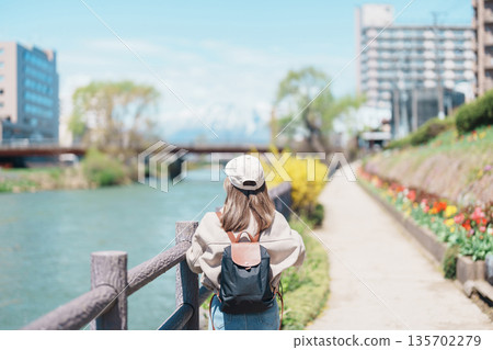 Woman tourist sightseeing Iwate mountain and Kitakami river with flowers in Spring, happy traveler travel in Morioka city, Iwate prefecture, Japan. famous Landmark Travel and Vacation destination Woman tourist sightseeing Iwate mountain and Kitakami river with flowers in Spring, happy traveler travel in Morioka city, Iwate prefecture, Japan. famous Landmark Travel and Vacation destination 135702279
