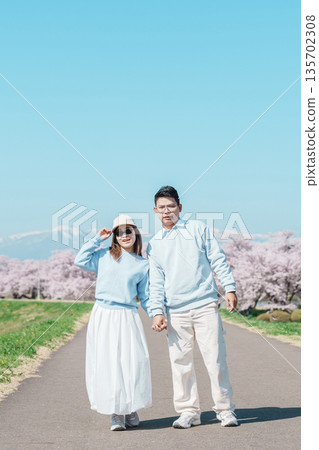 Couple tourist sightseeing Kitakami Tenshochi Park with Sakura Cherry Blossom in Spring, traveler travel in Kitakami festival, Iwate prefecture, Japan. Landmark for Travel and Vacation destination Couple tourist sightseeing Kitakami Tenshochi Park with Sakura Cherry Blossom in Spring, traveler travel in Kitakami festival, Iwate prefecture, Japan. Landmark for Travel and Vacation destination 135702308