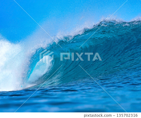Vast Ocean Wave Crashing Fiercely, Powerful Surf Surging Beneath Bright Sky 135702316