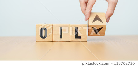 Hand change wooden block with OIL text to UP and Down arrow symbol icon. Trade war, stocks, financial, cut loss and economic concept 135702730