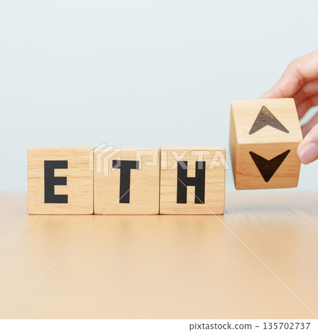 Hand change Wooden block with ETH or Ethereum text to UP and Down arrow symbol. cryptocurrency, blockchain, price, down and up, decrease and increase, cut loss, trade and financial concepts 135702737