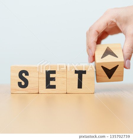 Hand change wooden block with SET text or The Stock Exchange of Thailand to UP and Down arrow symbol icon. decrease and increase, price, stocks, financial, trade, value and Cut loss concept 135702739