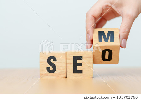 Hand change Wooden block from SEO to SEM. Search Engine Optimization, SEA, Advertising, Marketing, Idea, Strategy, Keyword, Content and technology concept 135702760