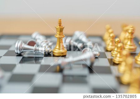 gold Chess King figure and Checkmate opponent during chessboard competition. Strategy, Success, management, business planning, win, disruption, Trade war and leadership concept 135702805