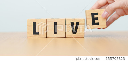 hand change wooden block Live to Life. Lifestyle, Live your life, learning, motivation and mindset concepts 135702823