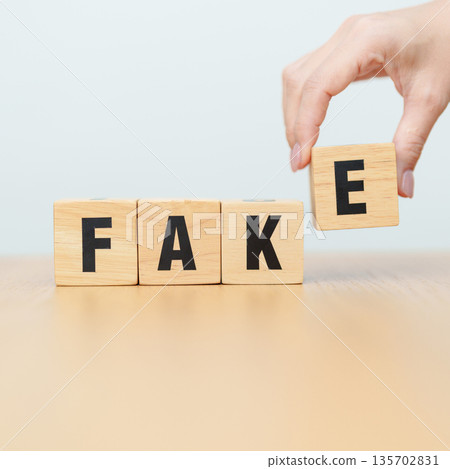 wooden block FAKE . rumor News, false, myth, evidence and disinformation concepts 135702831