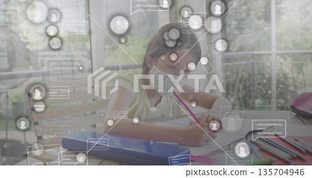Drawing schoolgirl wearing face mask using pink pencil at home learning area, with digital icons Drawing schoolgirl wearing face mask using pink pencil at home learning area, with digital icons 135704946