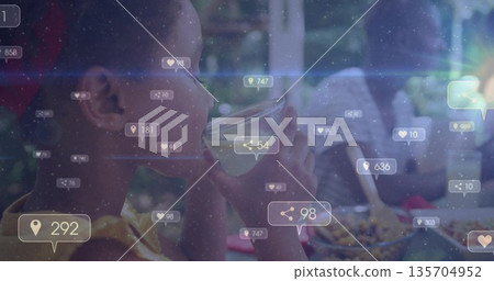 Child in yellow shirt drinking juice at kitchen table, with glass and social icons, copy space Child in yellow shirt drinking juice at kitchen table, with glass and social icons, copy space 135704952