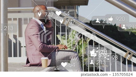 Man in pink blazer holding smartphone, typing on laptop on stairs, with coffee cup, copy space 135705024