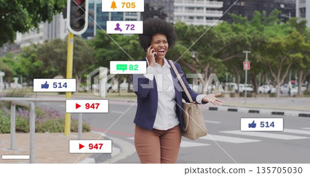 Crossing businesswoman talking on smartphone at crosswalk, with notification icons Crossing businesswoman talking on smartphone at crosswalk, with notification icons 135705030
