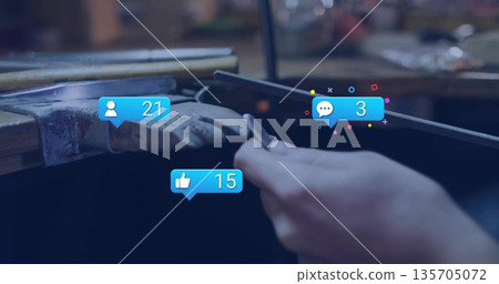 Filing woman's hands filing metal rod over wooden bench pin in workshop, with social media icons 135705072