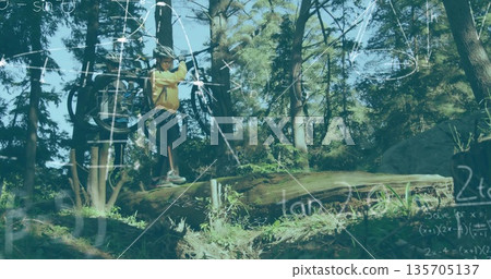 Balancing cyclist shouldering mountain bike on forest trail, with helmet backpack and math overlays Balancing cyclist shouldering mountain bike on forest trail, with helmet backpack and math overlays 135705137
