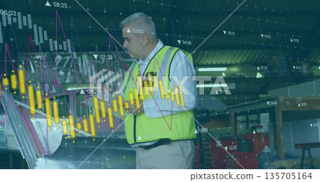 Senior technician wearing yellow safety vest inspecting engine bay inside garage, with data overlay 135705164