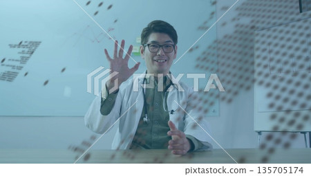 Waving doctor in lab coat gesturing at table in office, with stethoscope glasses whiteboard overlay Waving doctor in lab coat gesturing at table in office, with stethoscope glasses whiteboard overlay 135705174