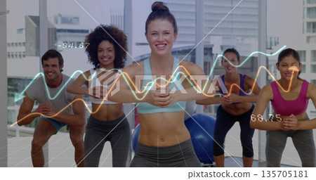 Squatting instructor wearing sports bra and leggings in studio, with stability ball, waveform data Squatting instructor wearing sports bra and leggings in studio, with stability ball, waveform data 135705181